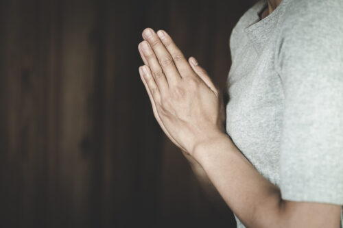 person praying hands together