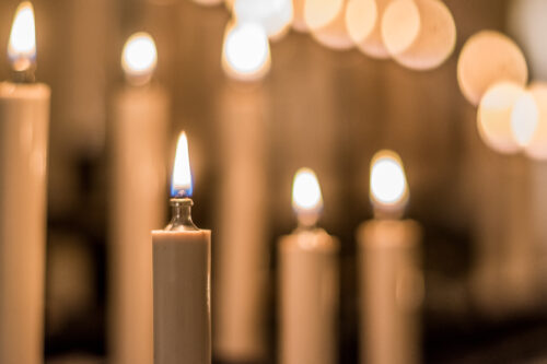 Faith, spirituality and religion concept. Oil lamp in candle shape light in church or temple