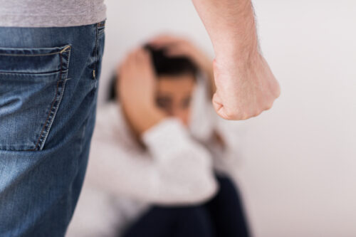 domestic violence, abuse and people concept - man beating helpless woman at home